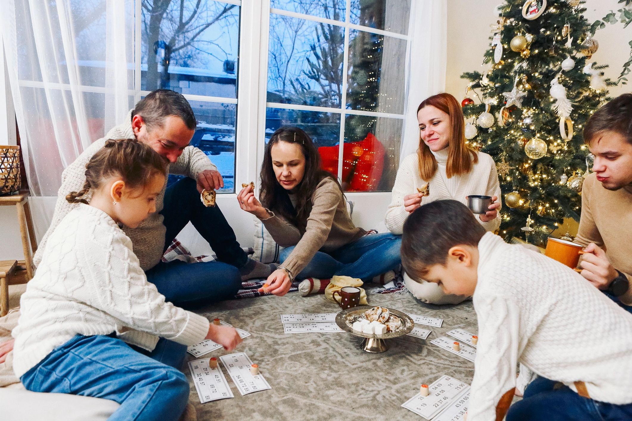 family playing tabletop games cozy home