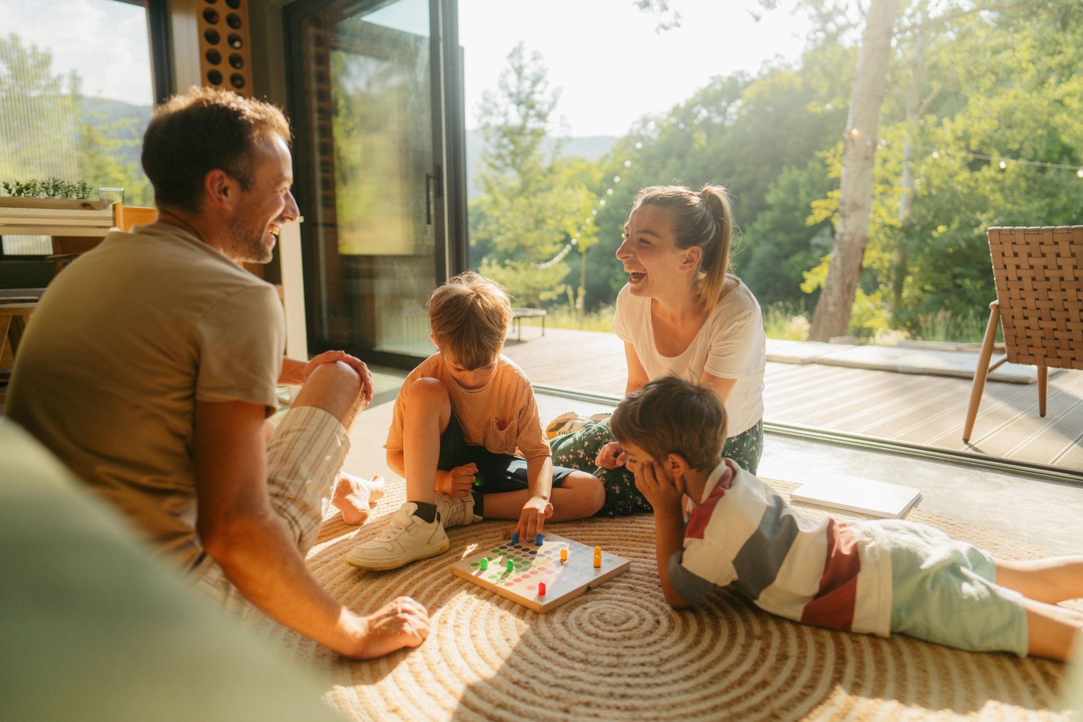 family playing tabletop board game together, warm light